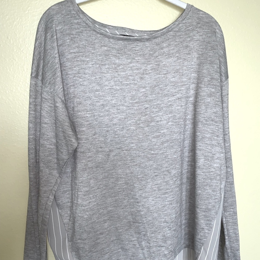 Ann Taylor woman’s, long sleeve, high-low blouse in grey. Size medium.